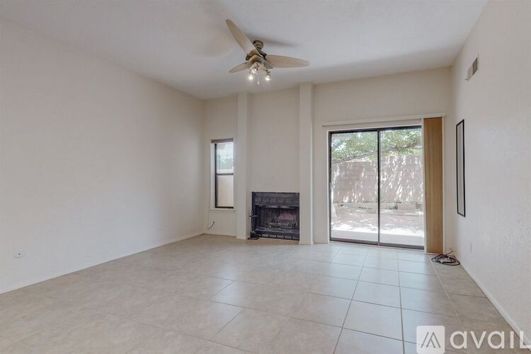 A spacious living room with a fireplace and sliding glass doors.