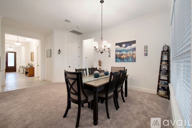 A dining room with a table set for four.