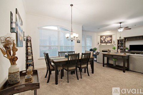 A living room with a dining table and chairs.