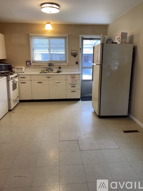 A kitchen with white appliances and a white refrigerator.