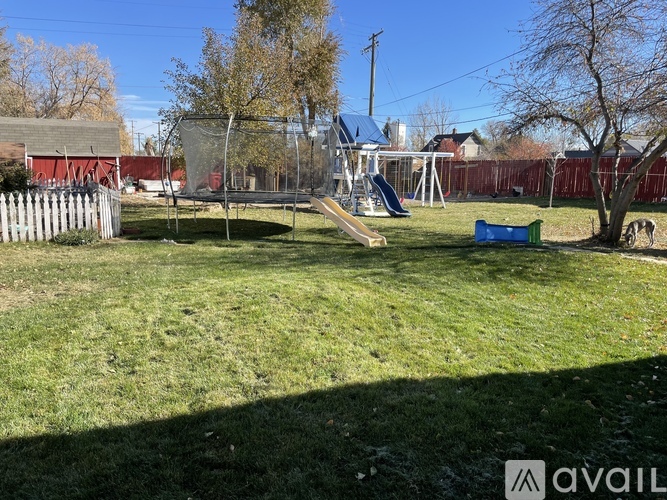 A backyard with a playground and a slide.