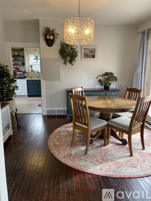 A dining room with a table and chairs.