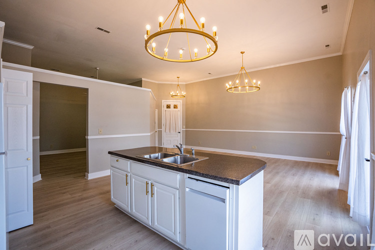 A kitchen with a chandelier and a sink.