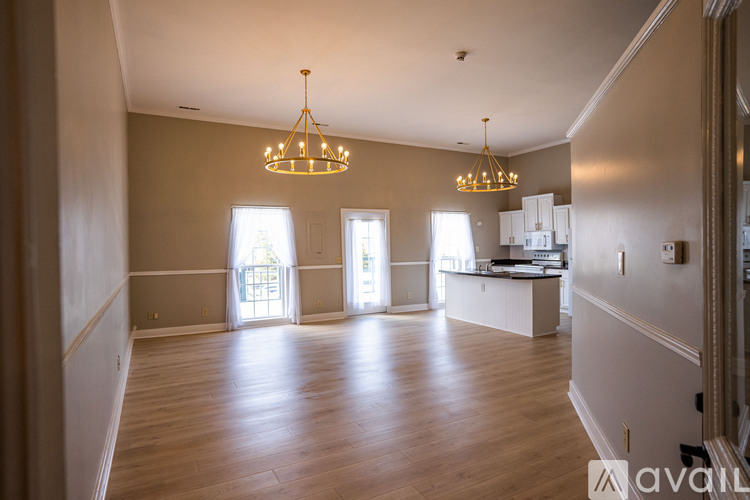 A spacious living room with hardwood floors and a large window.