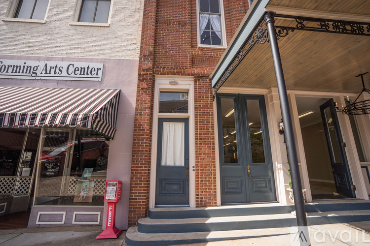 A building with a sign that says "Forming Arts Center" on it.