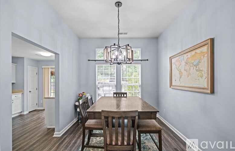 A dining room with a wooden table and chairs.