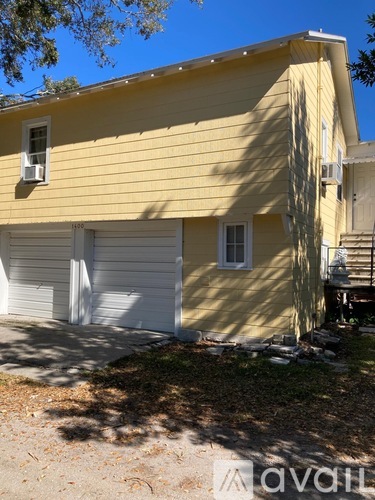 A yellow house with a white garage door.