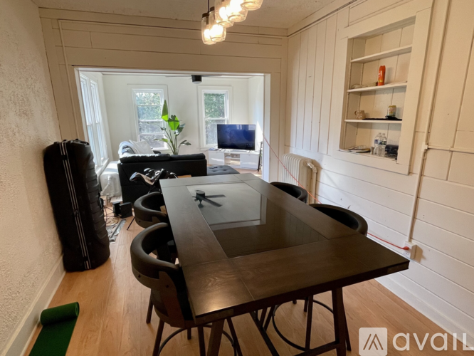 A dining room with a table and chairs.