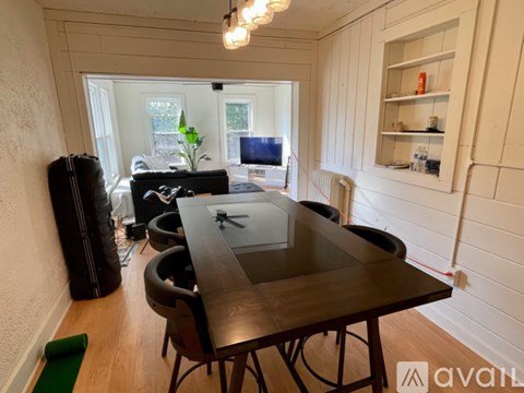 A dining room with a table and chairs.