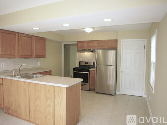 A kitchen with wooden cabinets and stainless steel appliances.