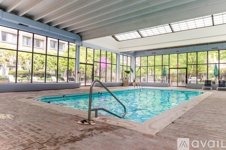 A pool inside a building with a glass ceiling.