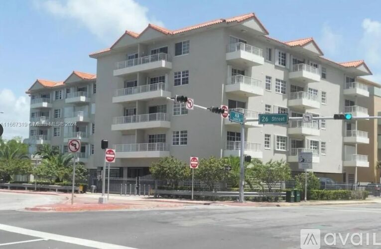 A street view of a residential building with a no parking sign.