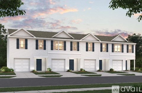 A white house with black shutters and a garage door.