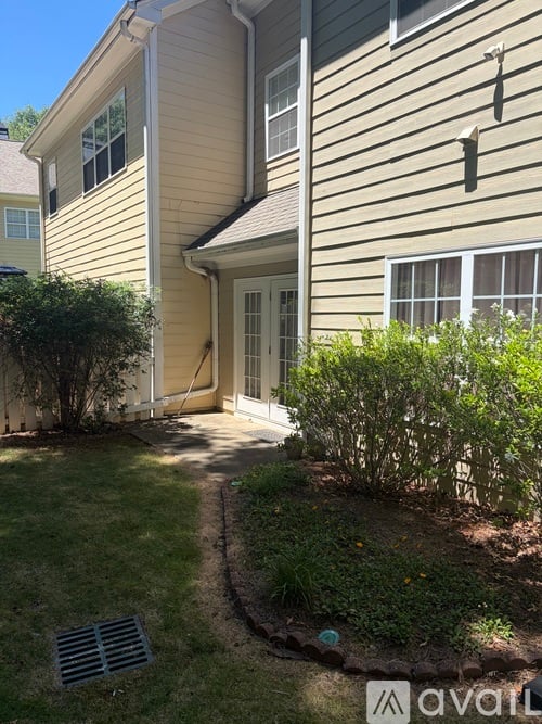 A house with a well-maintained lawn and a small garden.