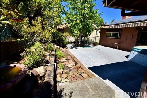 A backyard with a pool and a patio.