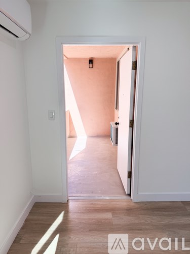 A hallway with a doorway leading to another room.