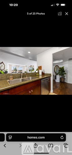 A kitchen with wooden cabinets and a granite countertop.
