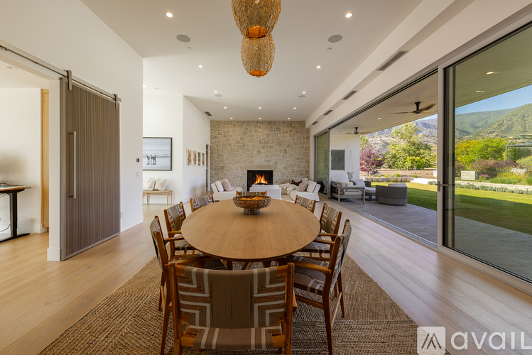 A modern dining room with a large table and chairs.