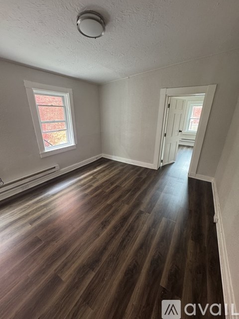 A room with wooden floors and a window.
