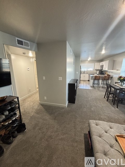 A living room with a grey couch and a television.