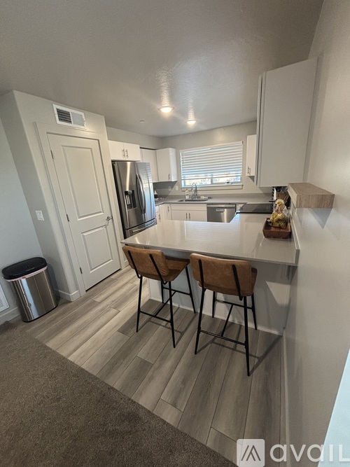 A kitchen with a table and chairs in the middle of the room.