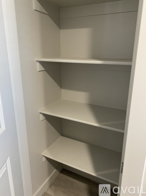 Empty white shelves in a room.