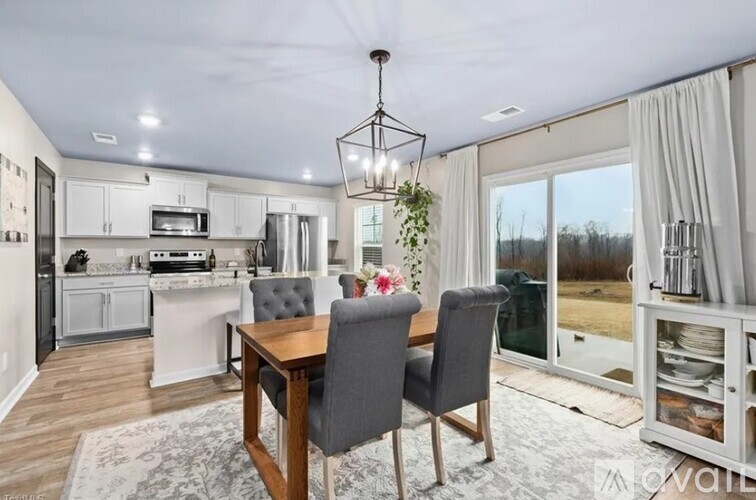 A modern kitchen with a dining table and chairs.