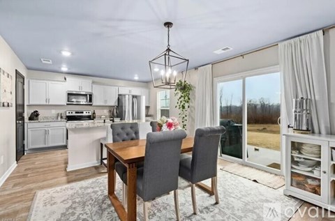 A modern kitchen with a dining table and chairs.