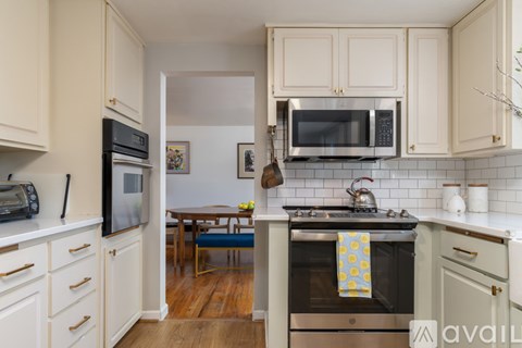 A kitchen with a stove top oven and a microwave above it.