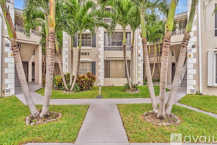 A building with the number 881 on it is surrounded by palm trees.