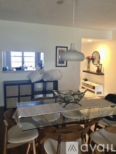 A dining room with a glass table and chairs.