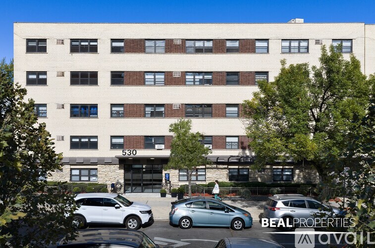 A building with the number 580 on it is surrounded by parked cars.