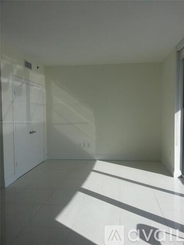 A white room with sunlight coming through the window.