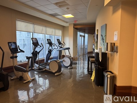 A gym with treadmills, exercise bikes, and elliptical machines.