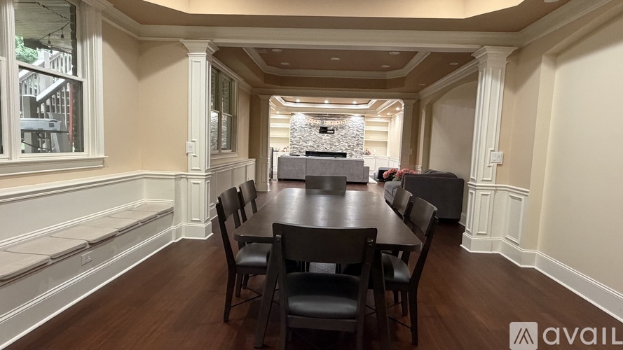 A dining room with a long table and chairs.