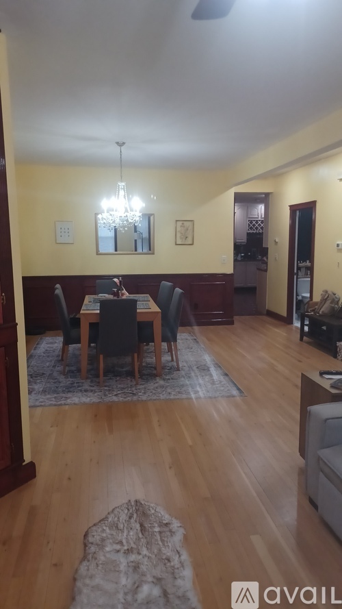 A dining room with a table set for four.