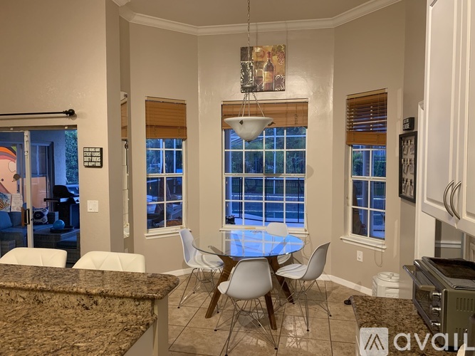 A dining room with a table and chairs.