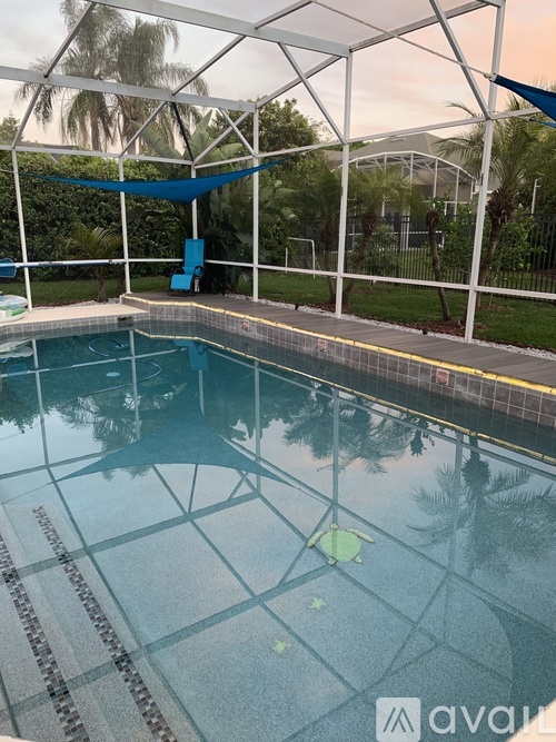 A pool with a blue tarp hanging over the edge.