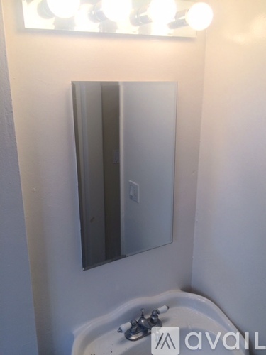 A bathroom with a sink and a mirror.
