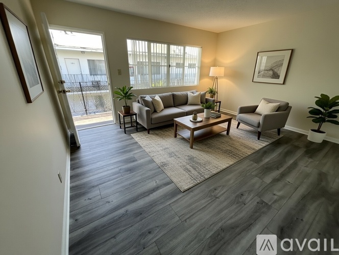 A living room with a grey couch, a coffee table, and a lamp.