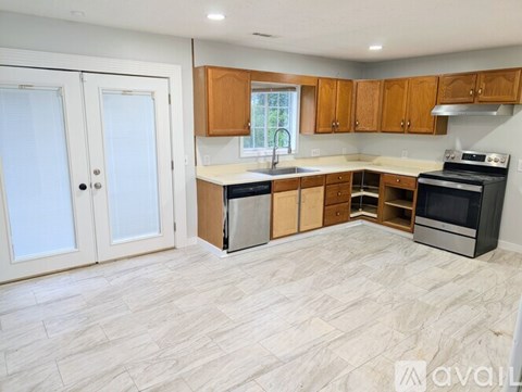 A kitchen with wooden cabinets and a white countertop.