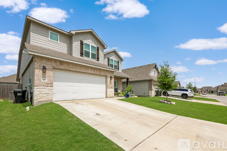 A house with a garage and a driveway is available for sale.