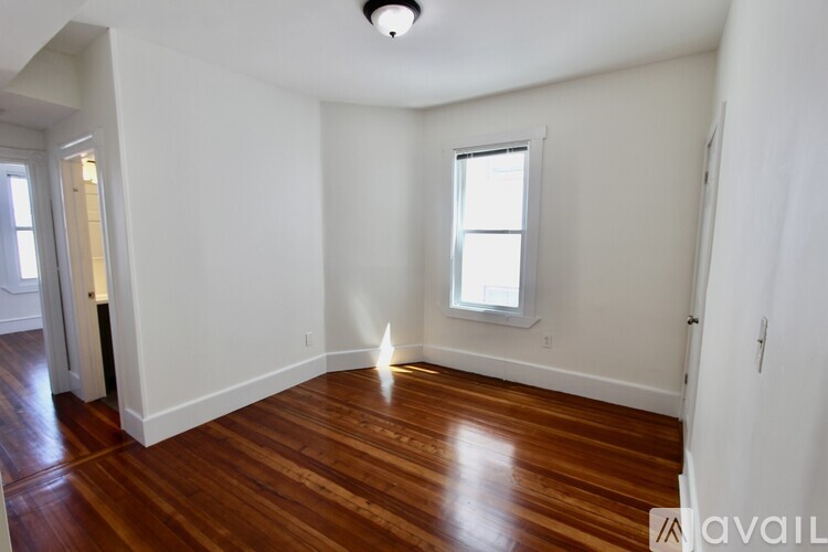 A room with wooden floors and a window.