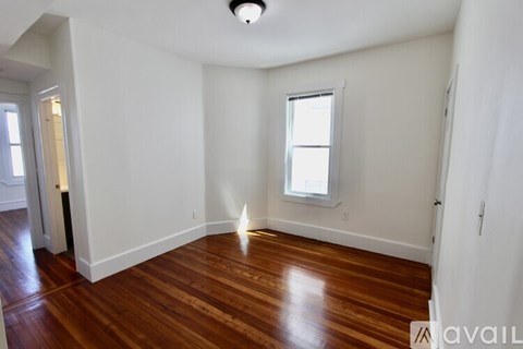 A room with wooden floors and a window.