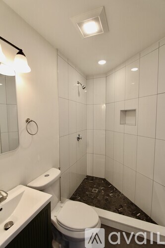 A bathroom with a toilet, sink, and tub.