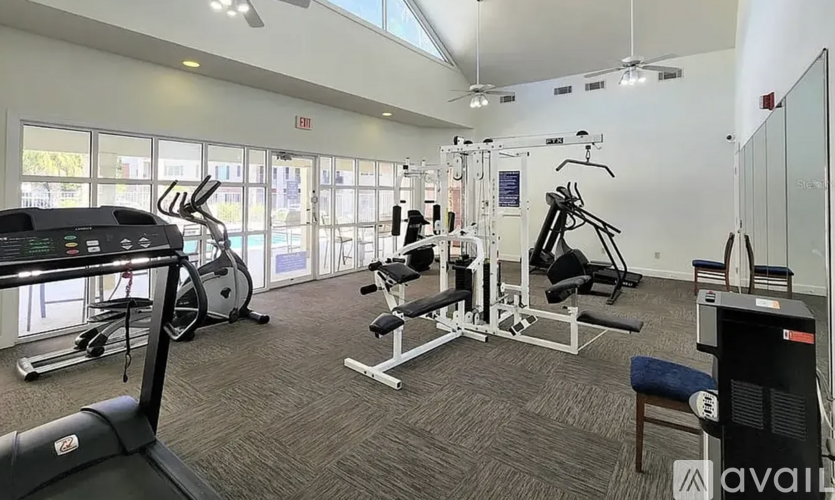 A gym with a treadmill, weights, and exercise equipment.