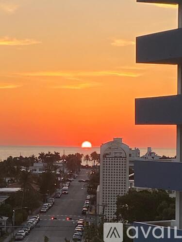 A sunset view from a high-rise building with the Avail sign visible.
