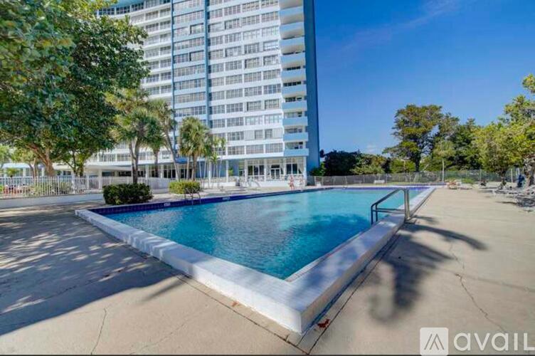 A swimming pool in a sunny outdoor setting.