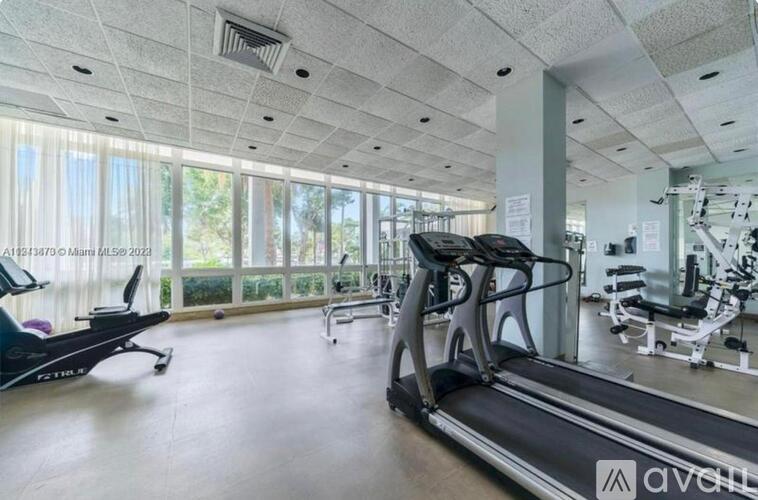 A gym with treadmills, exercise bikes, and other equipment.