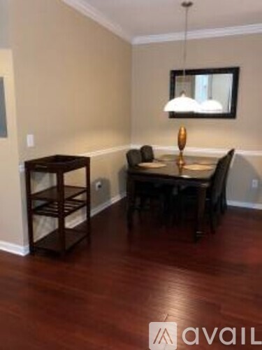 A dining room with a wooden table and chairs.